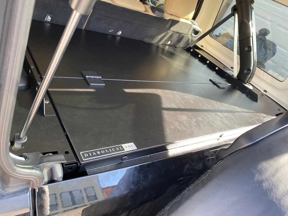 Slipstream folding top propped open on a JKU, Diabolical Inc badge on the edge