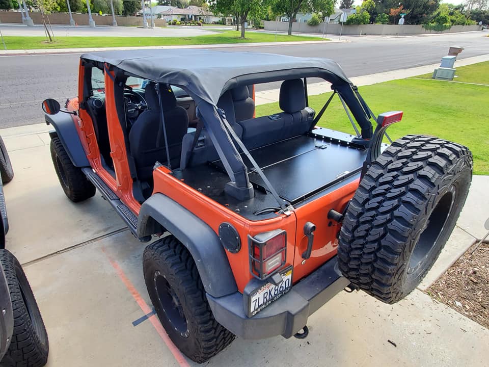 Orange JKU from the rear quarter with the Slipstream closed under a bikini top