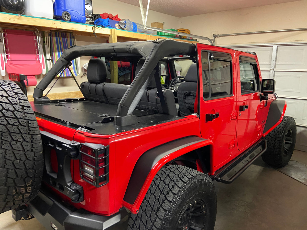 Red Jeep JKU in a garage with the Slipstream installed behind the rear seat