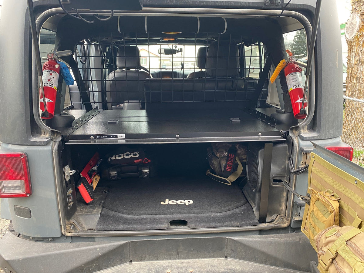 Gray JKU with the tailgate open showing gear stored under the Slipstream top
