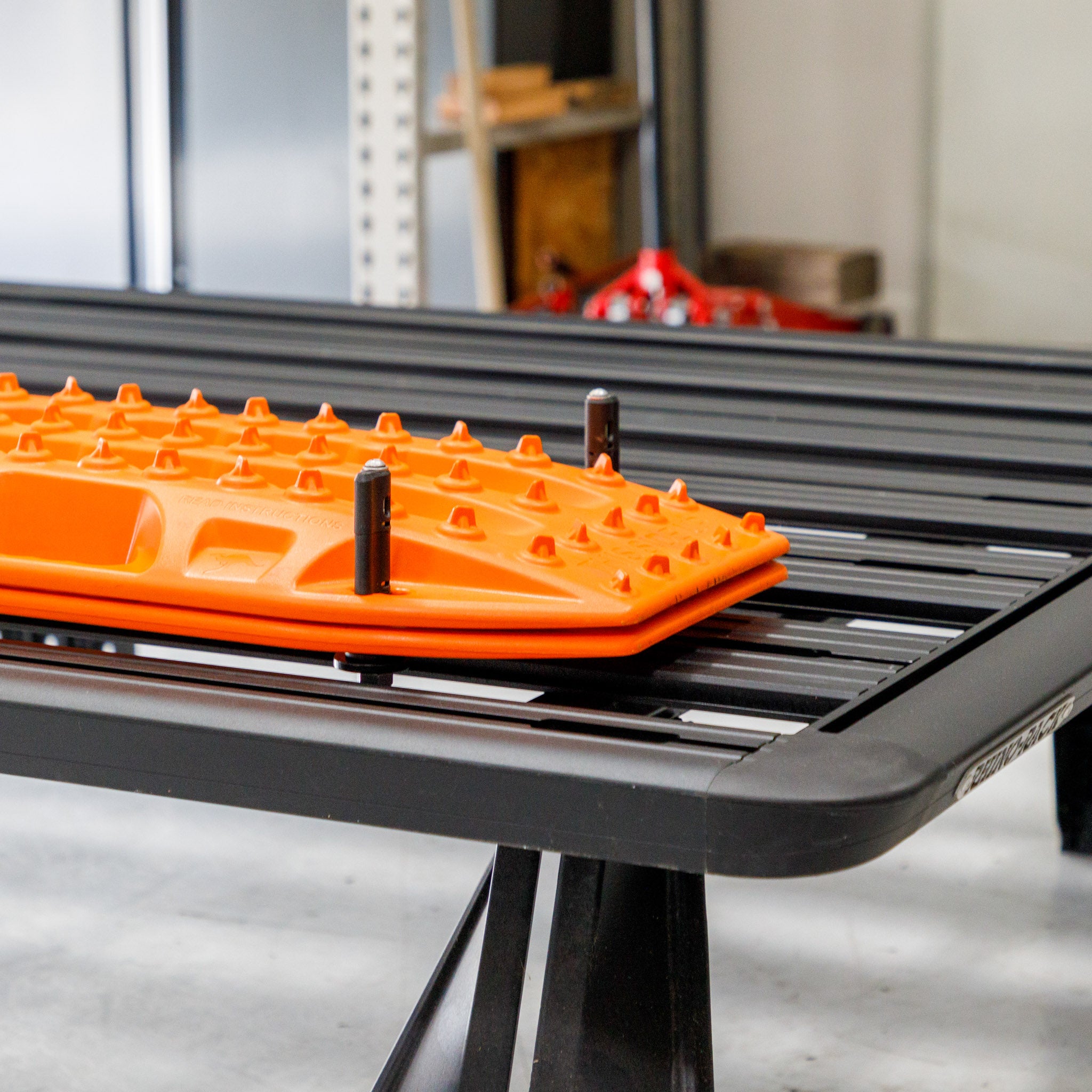 Overland Kitted Flat Rhino Rack Roof Rack Mount For MAXTRAX - mount with orange Maxtrax on a Rhino Rack Roof rack