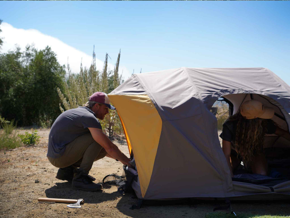 C6 Rev Tent (Element) – people setting up the tent at camp