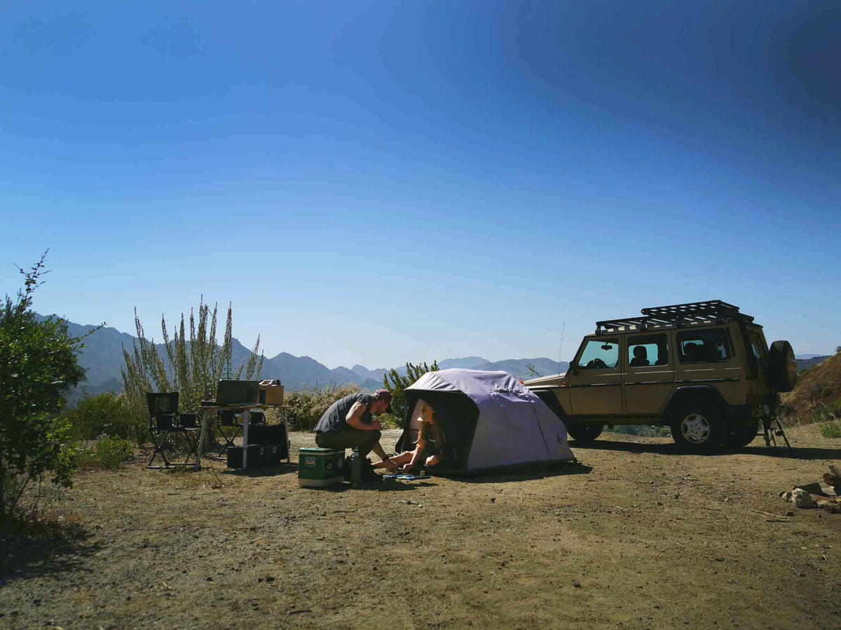 C6 Rev Rooftop Tent X (HellaStorm) – camp scene with a ground tent and vehicle