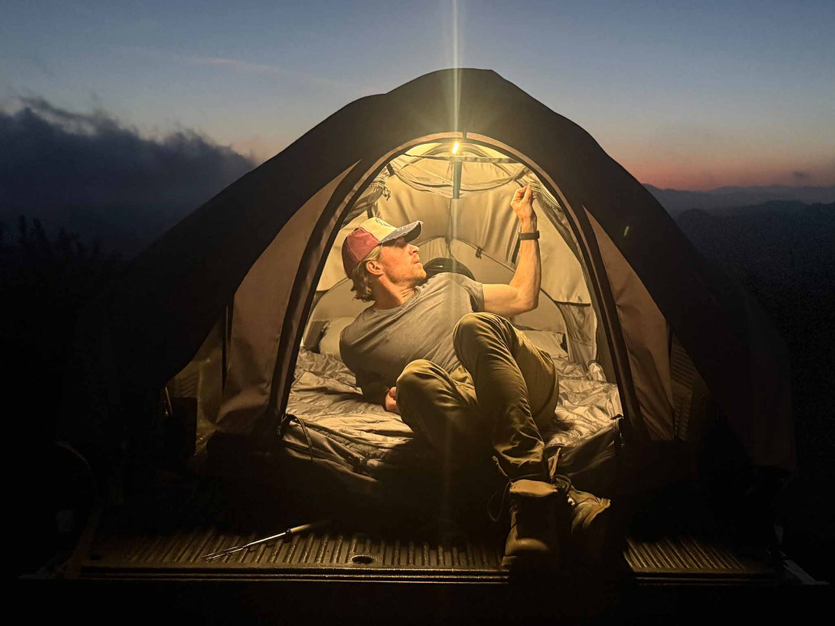 C6 Rev Pickup Truck Tent – lit interior at dusk