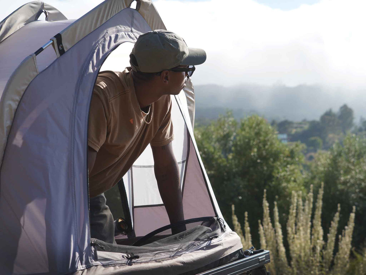 C6 Rev Rack Tent (HellaStorm) – person inside the open tent