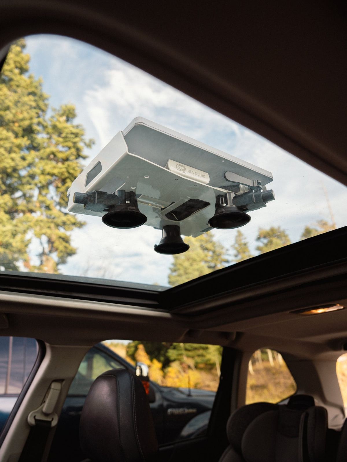 Revolink mount on suction cups seen from inside a vehicle through a glass sunroof