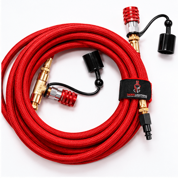 Close-up of the brass T-fitting and quick-connect coupler on a red StrikeShield braided hose
