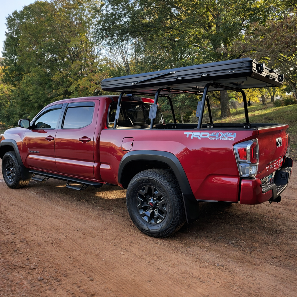 HMOR bed bars on a red 3rd gen Toyota Tacoma carrying a hard-shell rooftop tent
