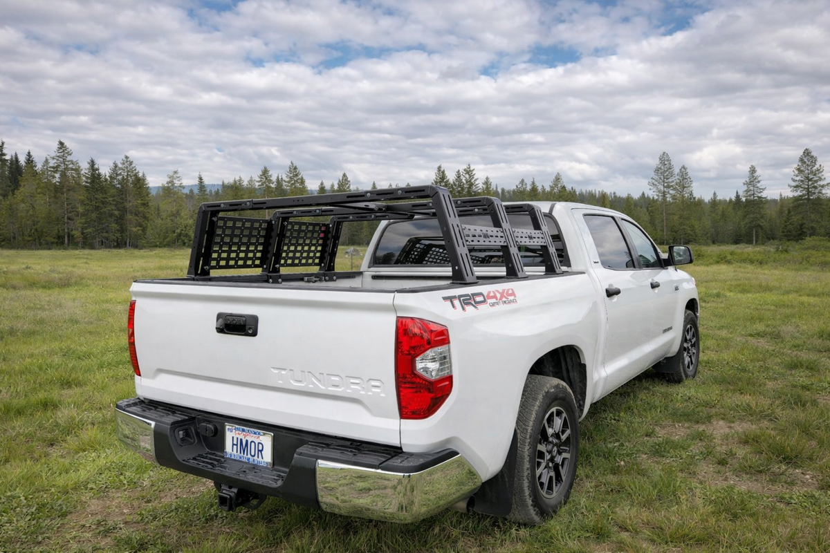 White Tundra TRD with low ROCK-IT rack in a meadow