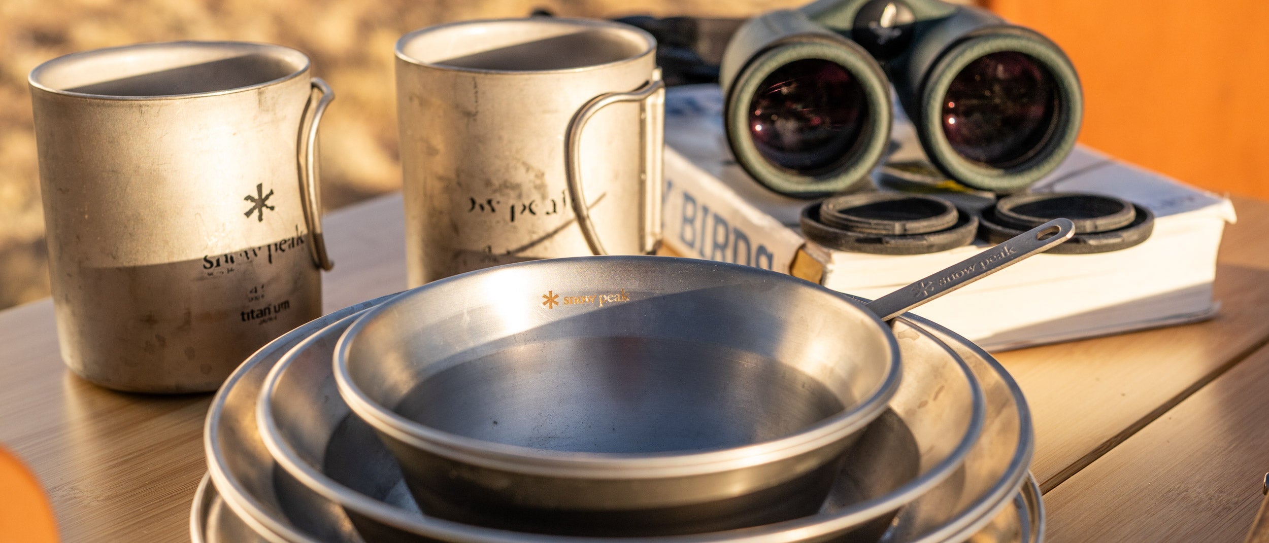 Snow Peak Utensils, Plates and Mugs on a camp table