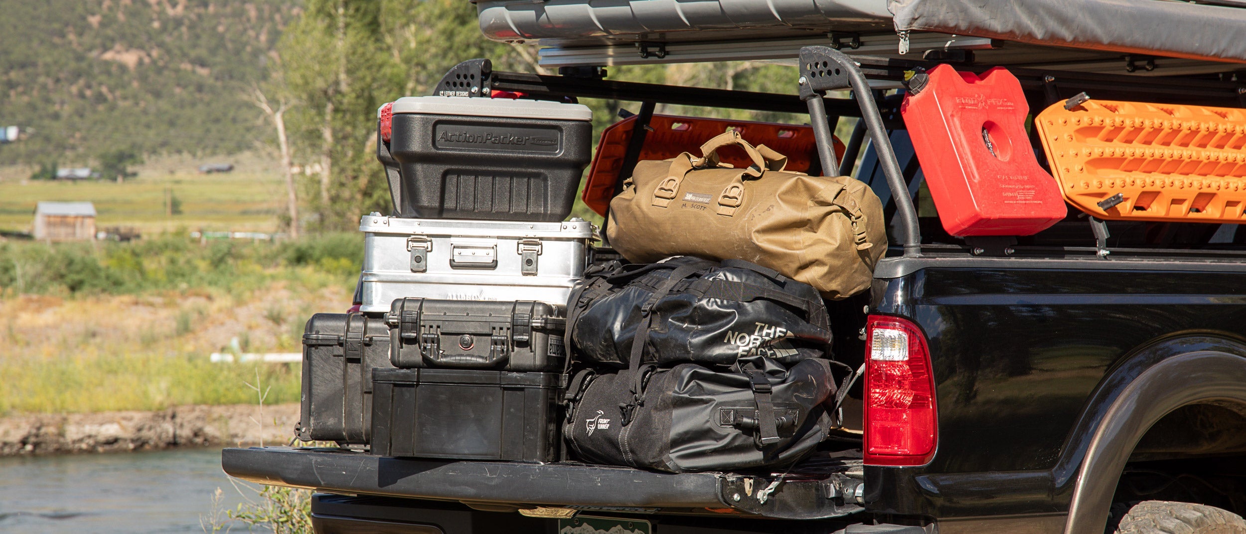 Durable storage solutions for overlanding gear, featuring AluBox cases, Leitner Designs systems, and versatile storage bags.