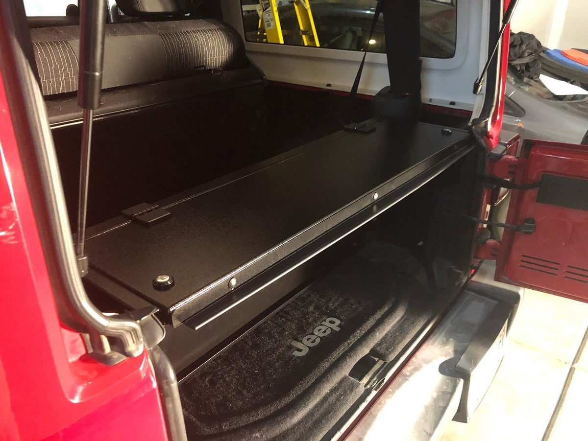 Locker installed behind the rear seat of a red JK 2-door, tailgate open