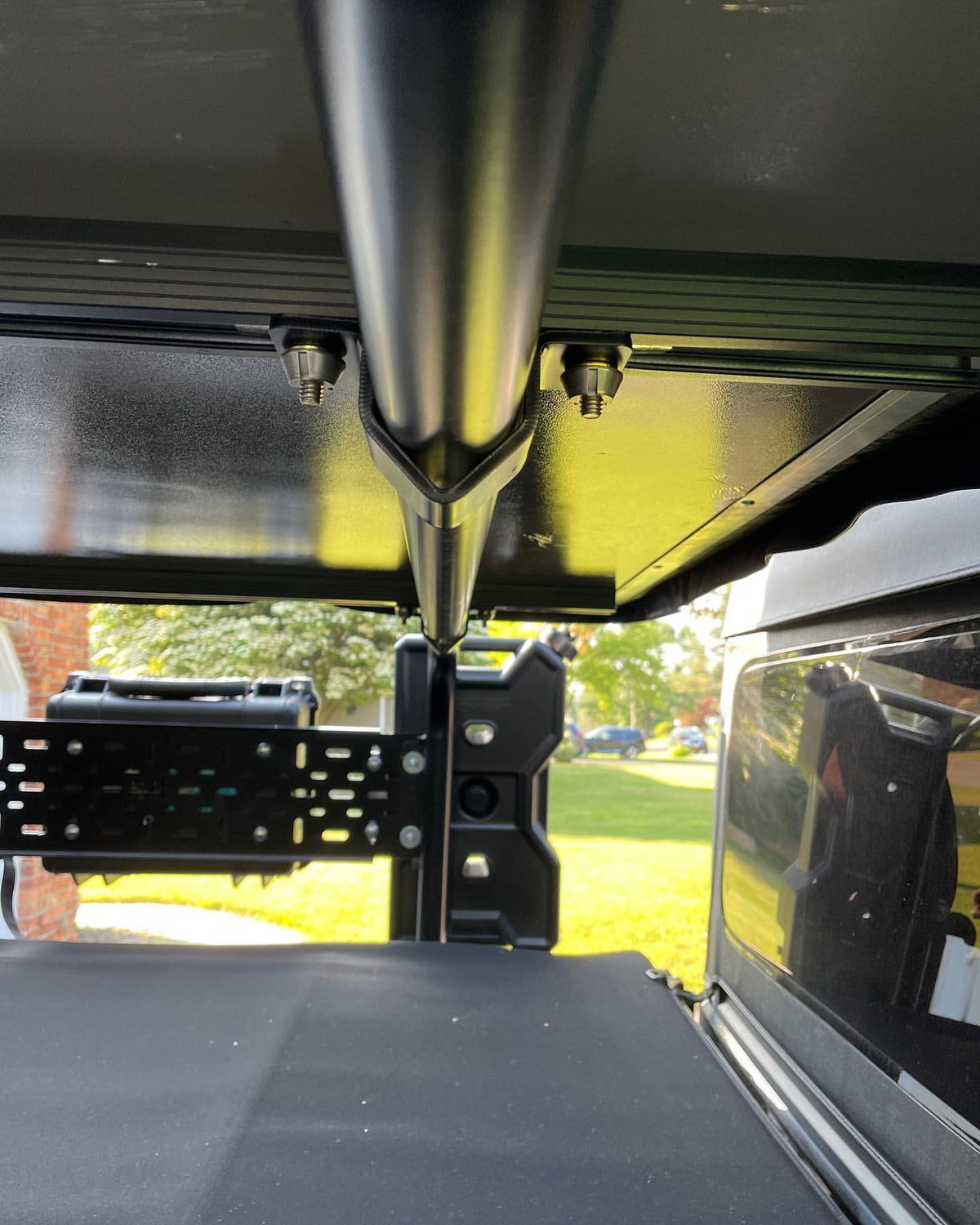 Two security mounts under a rooftop tent base on bed bars