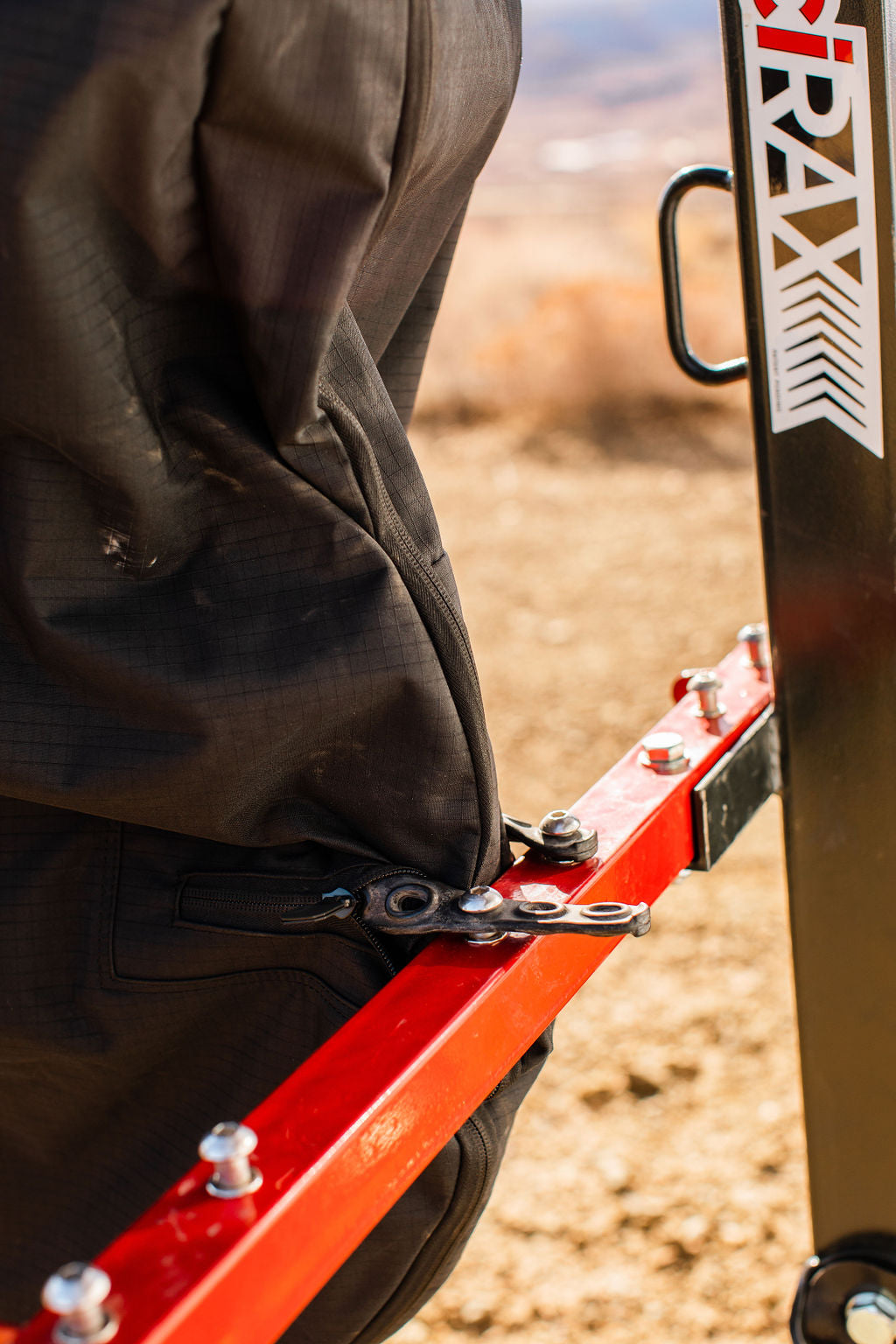 Detail of the modified cover's front wheel strap point on the red VelociRAX arm