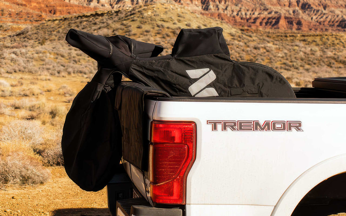 Covered mountain bike draped over the tailgate of a Ford Super Duty Tremor