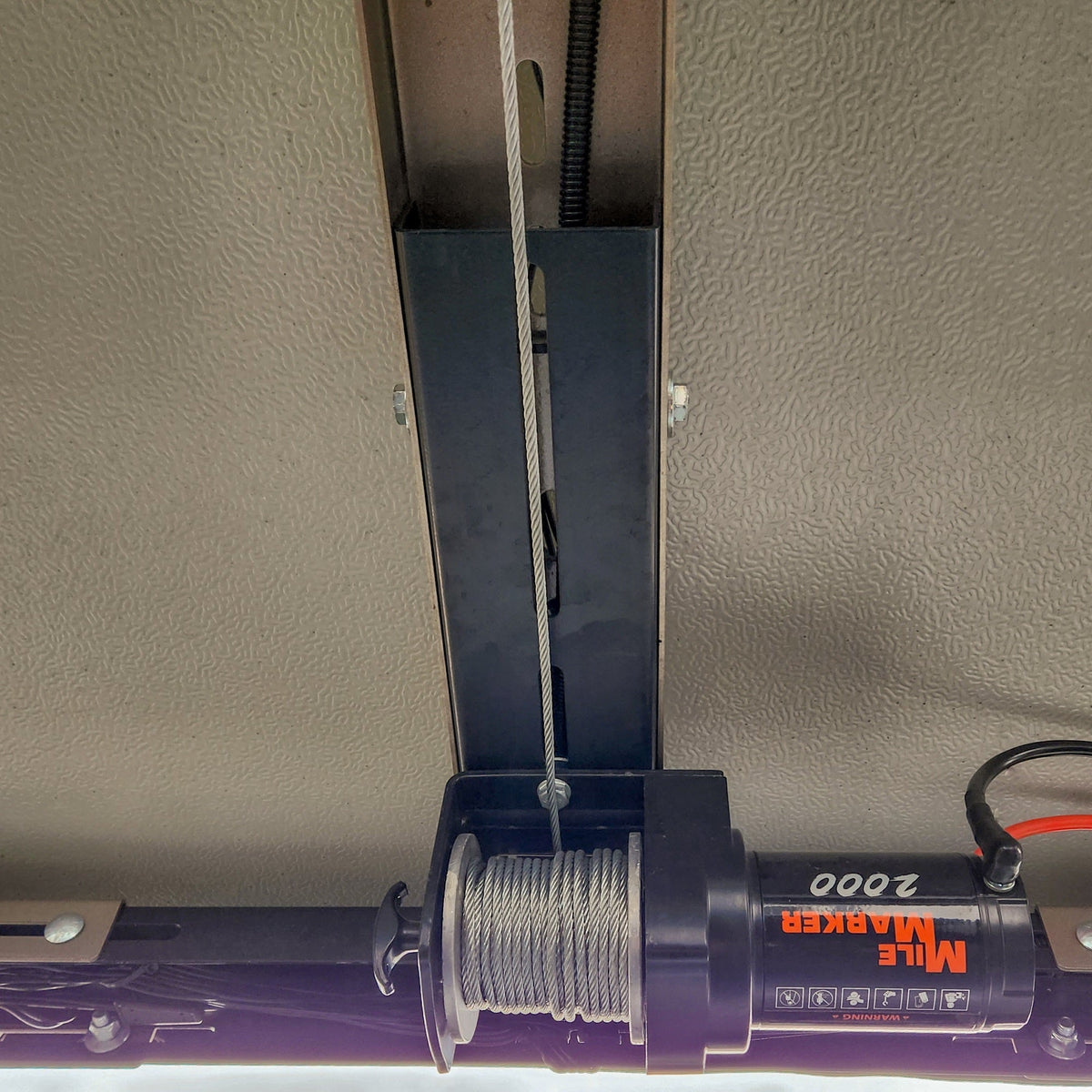 Winch cable running down from the mount through the rack