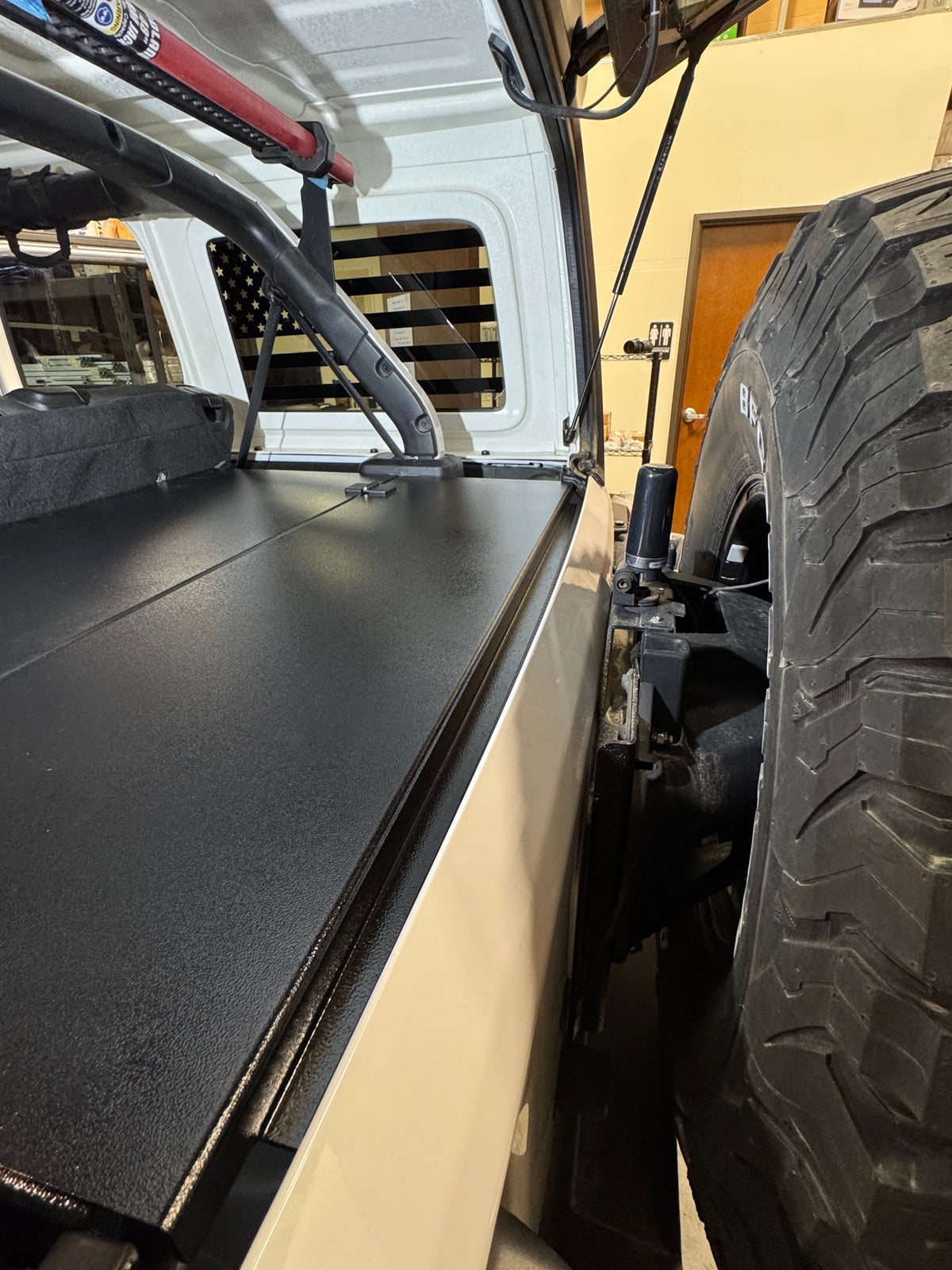 Ridgeback in a JLU beside the swing-out spare tire