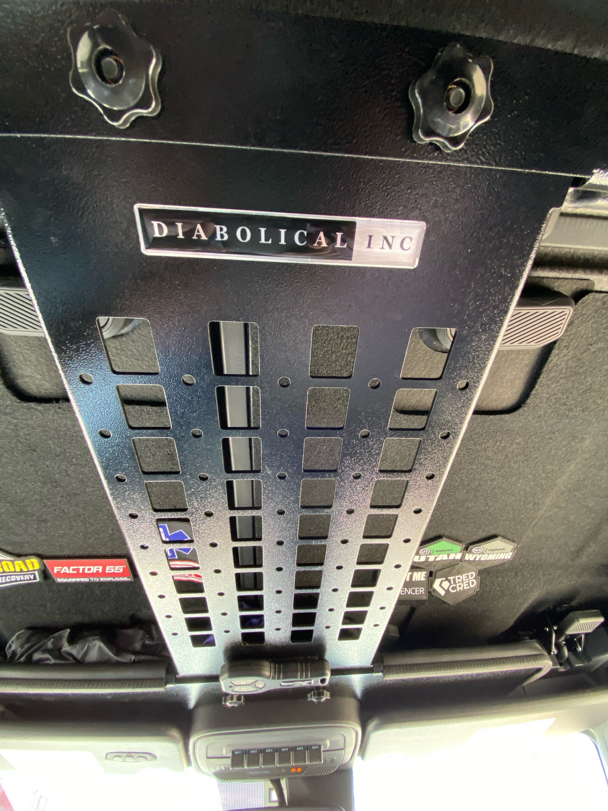 Diabolical Bronco Spine perforated overhead panel with spin knobs and badge