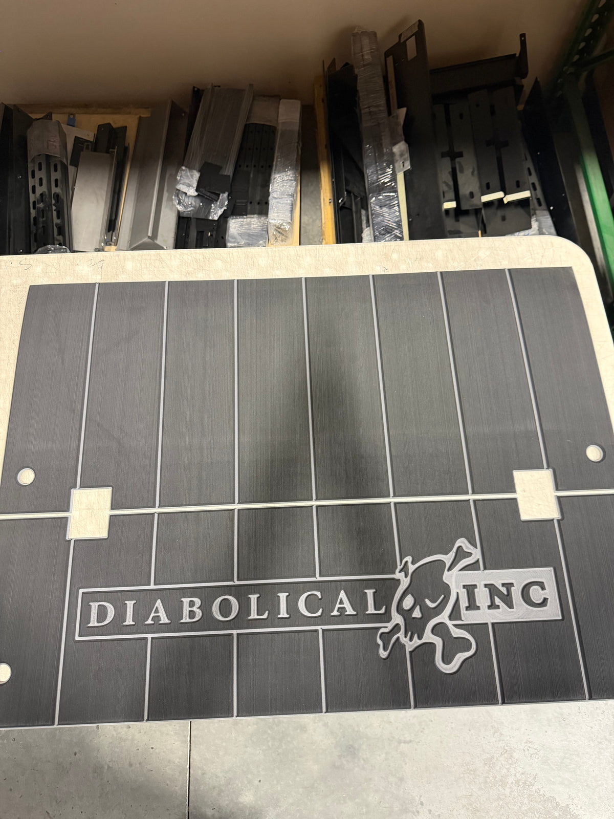 Gray teak-style foam pad with the engraved Diabolical Inc logo