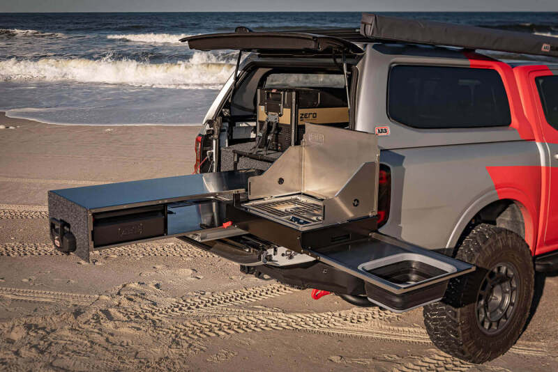 ARB Complete Slide Kitchen fully deployed with two-burner stove and stainless benchtop