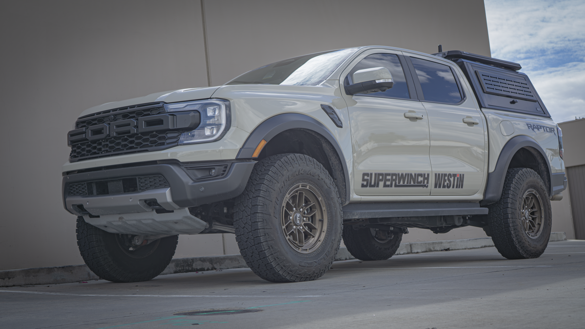 Front three-quarter view of a 2024+ Ford Ranger Raptor with a bed canopy, the truck the Mountain Hatch panel is photographed on