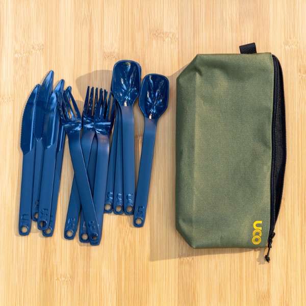 Overhead view of the navy blue utensils fanned out next to the utensil case