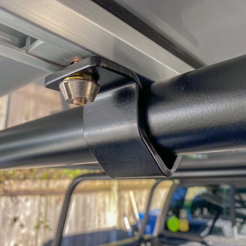 Security mount clamped around a horizontal tube under a tent