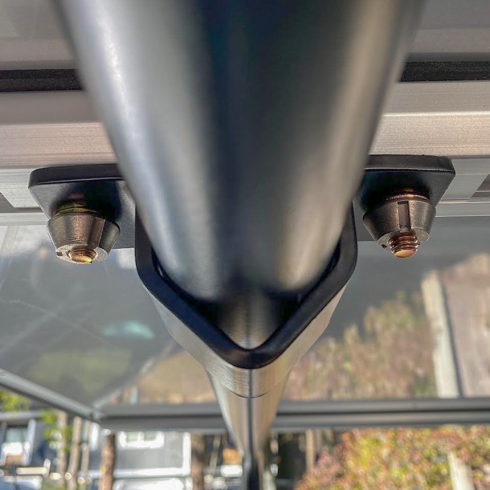 HMOR security mount clamping a rooftop tent rail to a bed bar, viewed from below