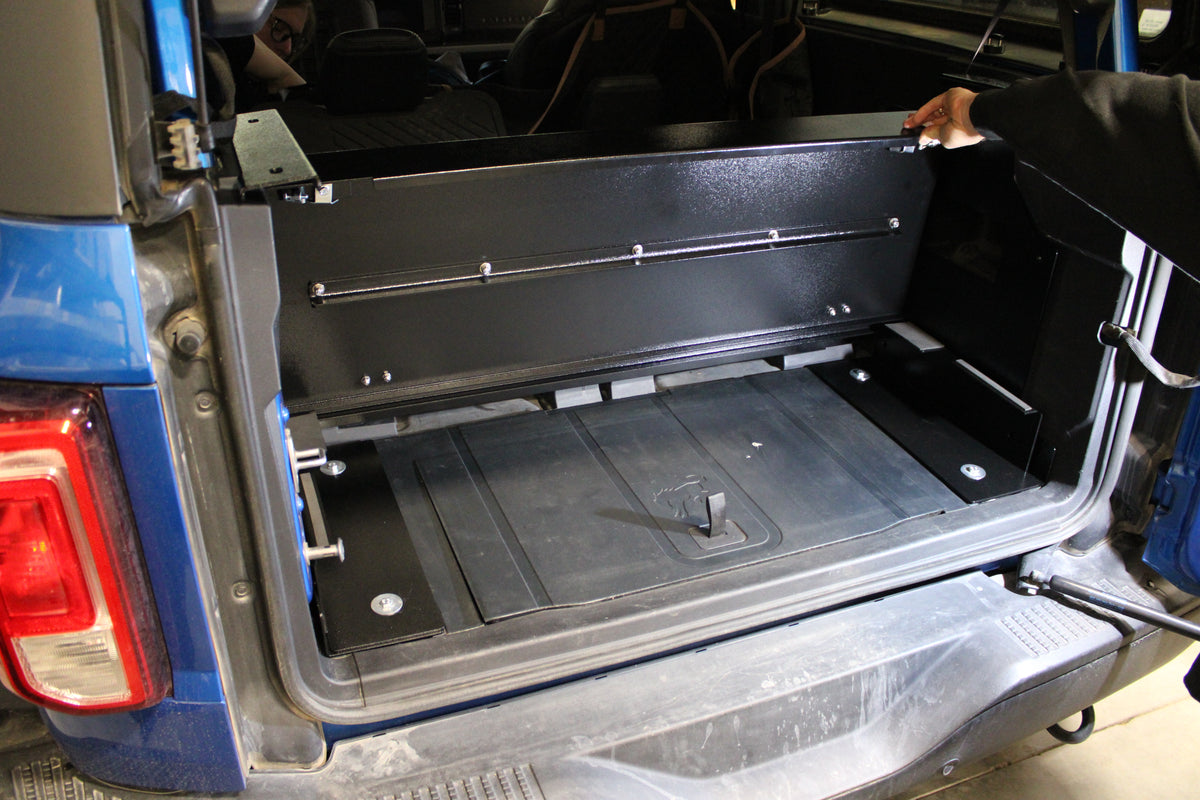 Stage lockable compartment opened in a blue Bronco