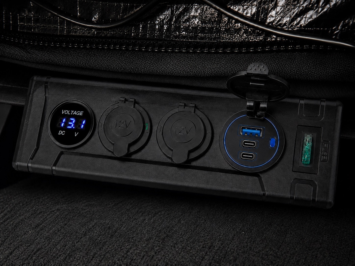 Close-up of the interior power panel with a voltage display, two round outlets and USB ports