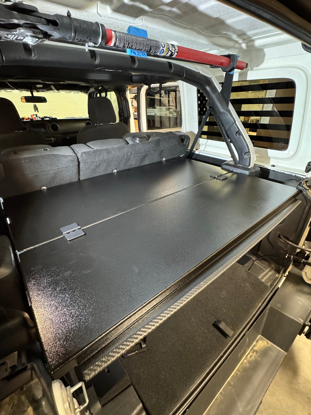 Ridgeback enclosure closed in a white Jeep JLU, roll bar and rear seat behind