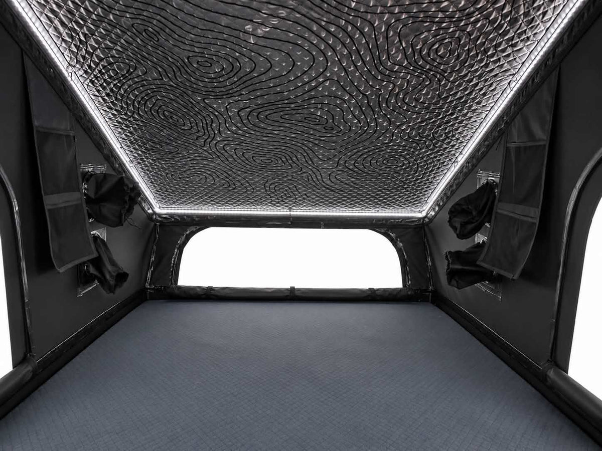 Interior of the Dark Rogue tent with white LED ceiling lighting, wall pockets and a rear window