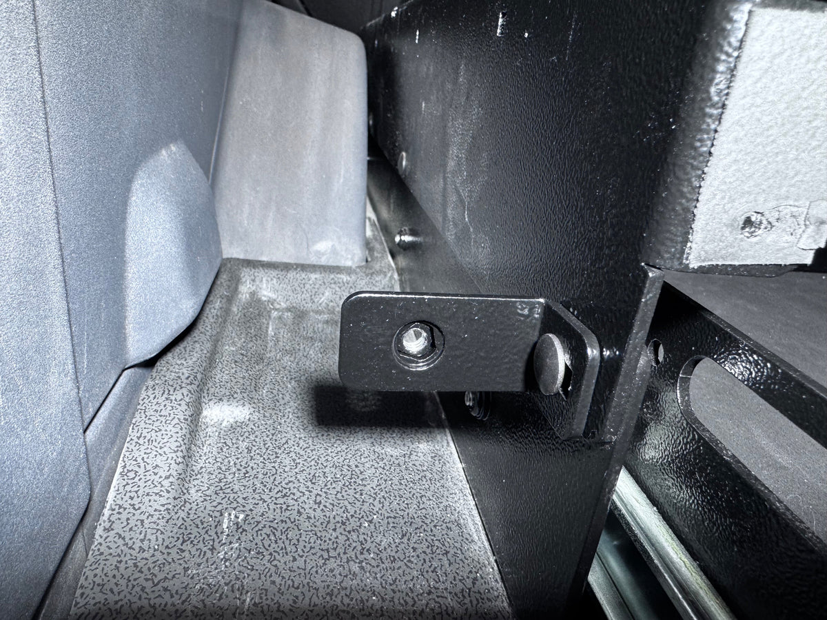 Leveling panel mounting bracket and hinge detail inside a Grenadier