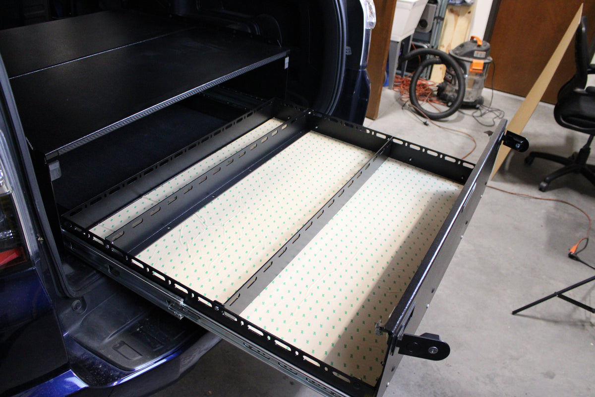 Diabolical Standard drawer pulled out of an SUV with a dotted foam mat in the tray