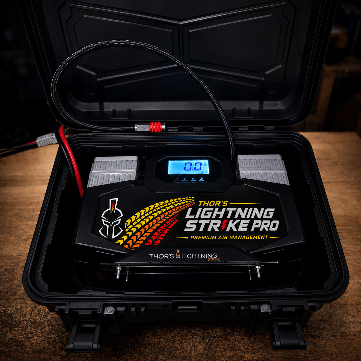 AirVault StrikePro with Heritage tire-tread faceplate in its open hard case, photographed on a wood workbench