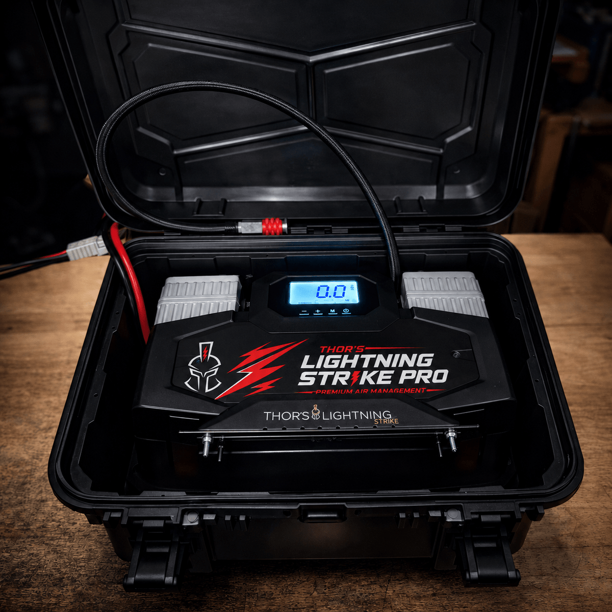 AirVault StrikePro with Standard faceplate in its open hard case, photographed on a wood workbench