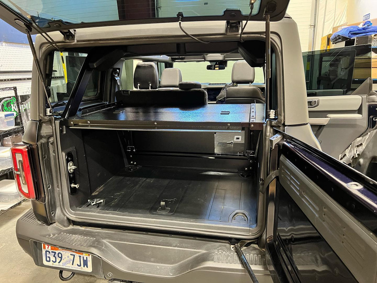 Rear view of a Bronco 4-door with the tailgate open and the Slipstream top raised