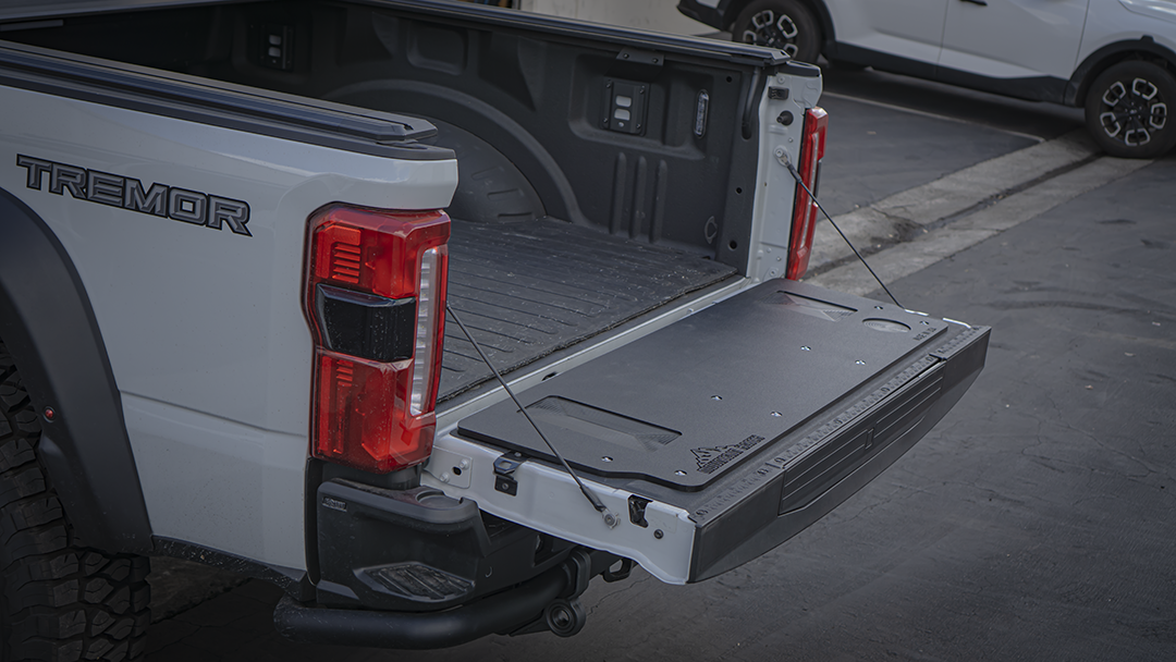Passenger-side view of a 2023+ Super Duty Tremor with the Mountain Hatch tailgate table on the lowered gate