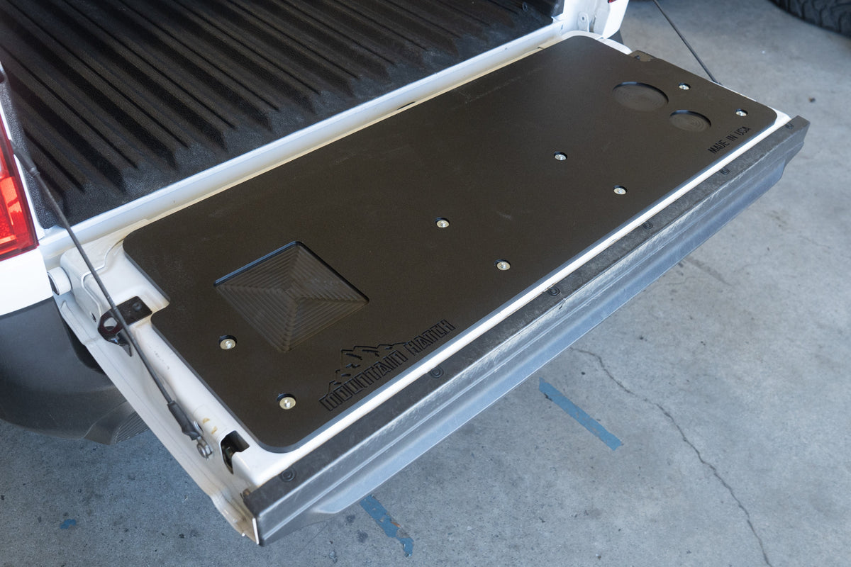 Ford Maverick tailgate lowered with the Mountain Hatch panel and its two drink holders at the right end