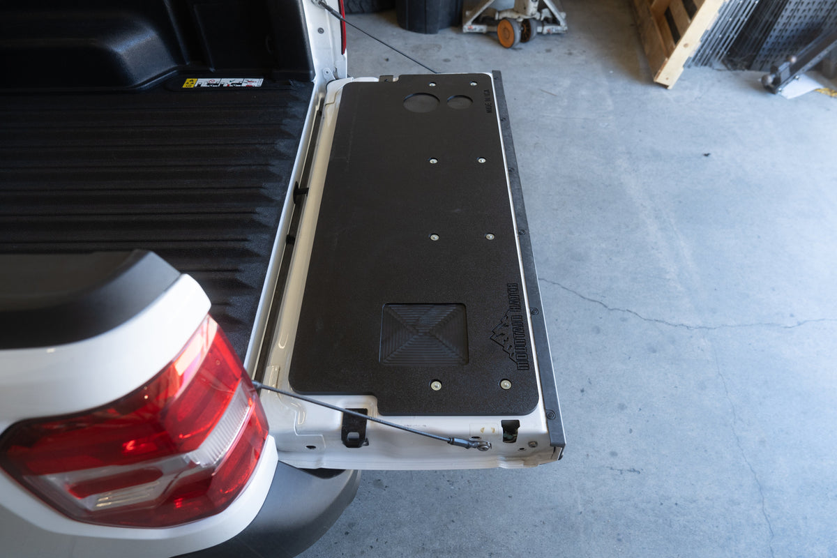 Ford Maverick parked in a shop with the Mountain Hatch tailgate table installed on the open tailgate