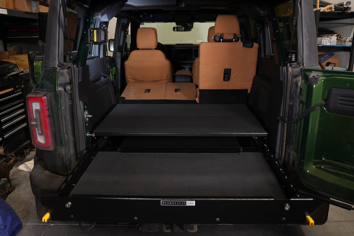 Green Bronco 4-door with the drawer tray pulled out under the deck