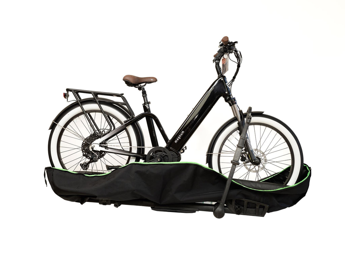Black step-through e-bike sitting in the cover's lower tray section before the top goes on