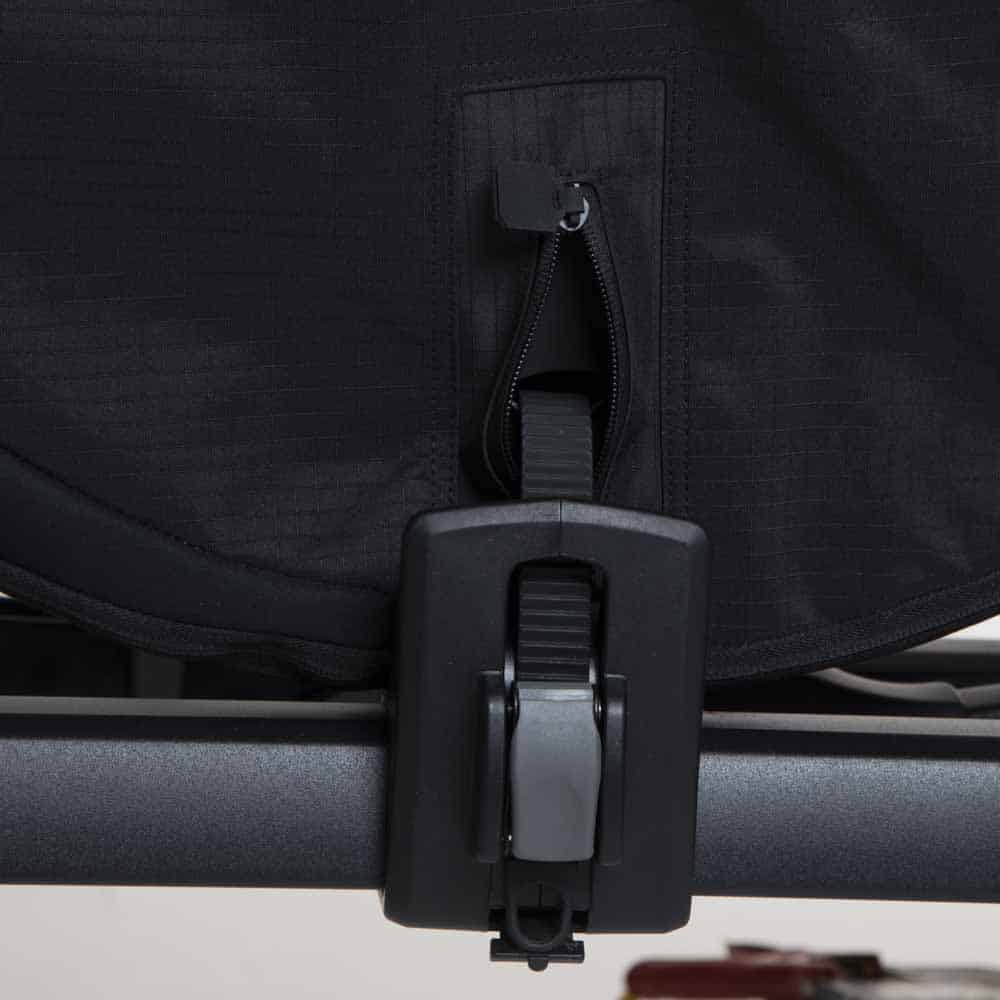 Tray rack wheel strap and ratchet clamped through the cover's reinforced pass-through