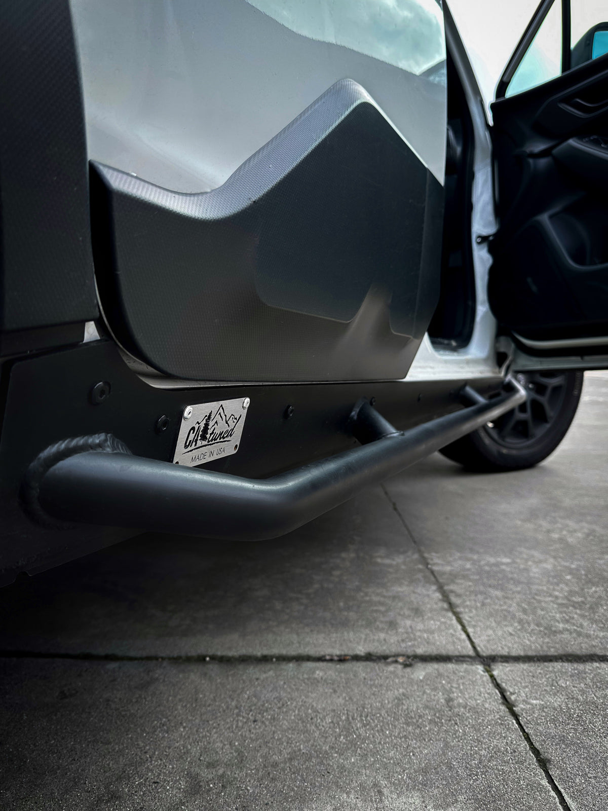 Close view of the slider end plate and tube beside an open door