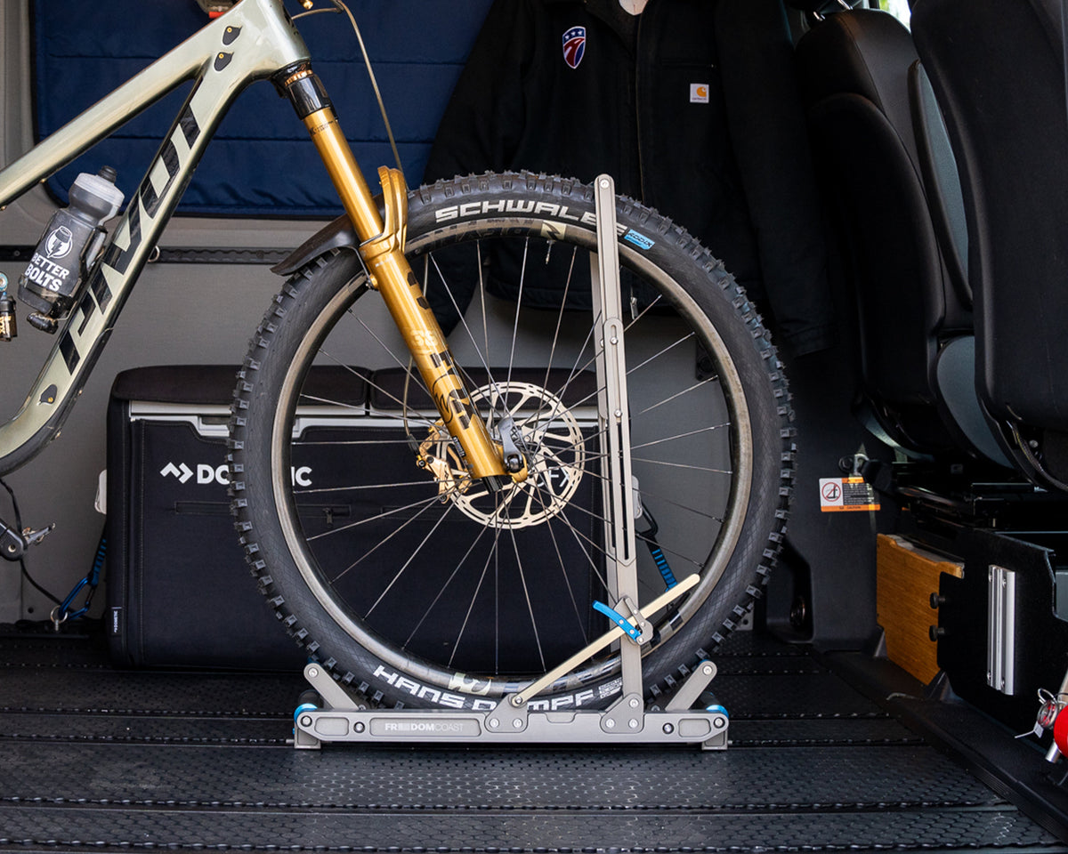 HOVR bike rack holding a mountain bike by the front wheel inside a van