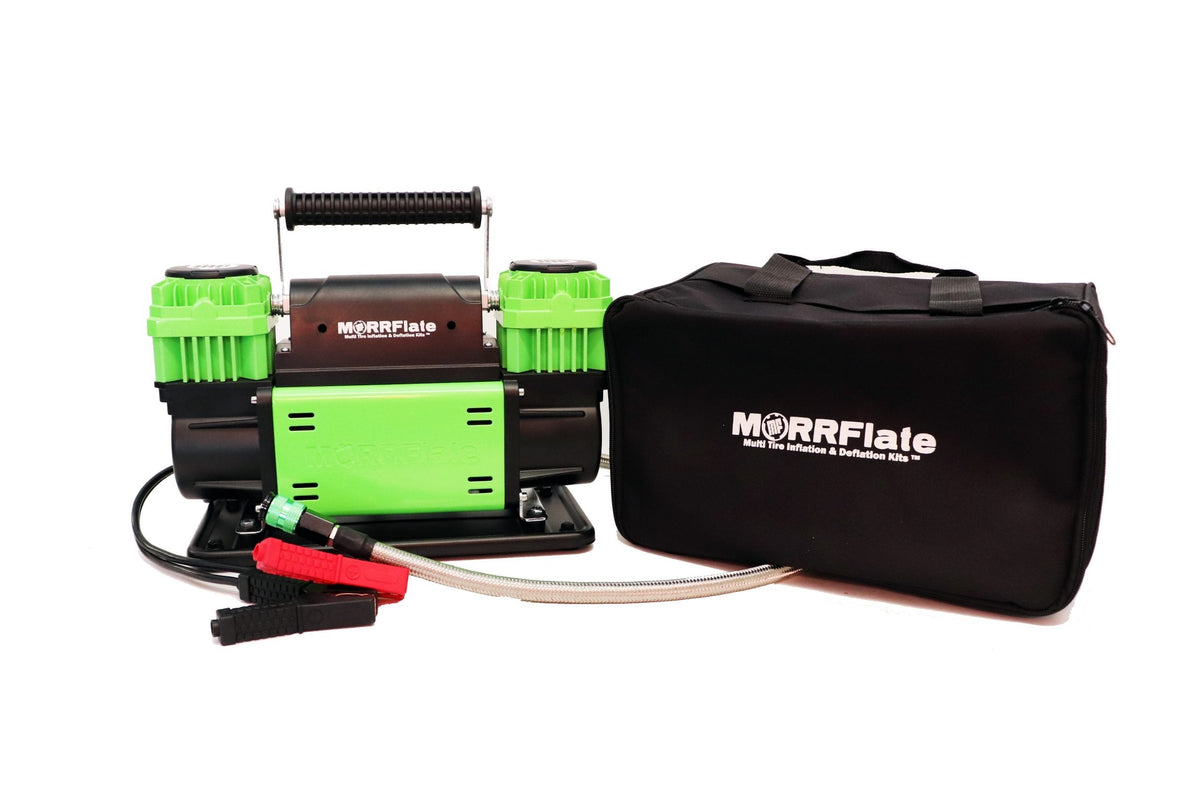 MORRFlate TenSix 12V portable air compressor with green cylinder heads, braided stainless steel hose, red and black battery clamps, and black MORRFlate carrying bag