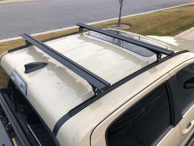 Eezi-Awn K9 load bars on a crew cab roof, side view