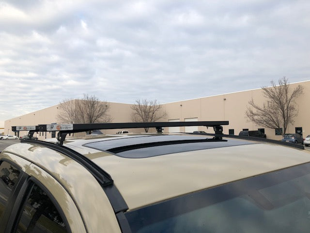 Eezi-Awn K9 load bars spanning a vehicle roof, side view