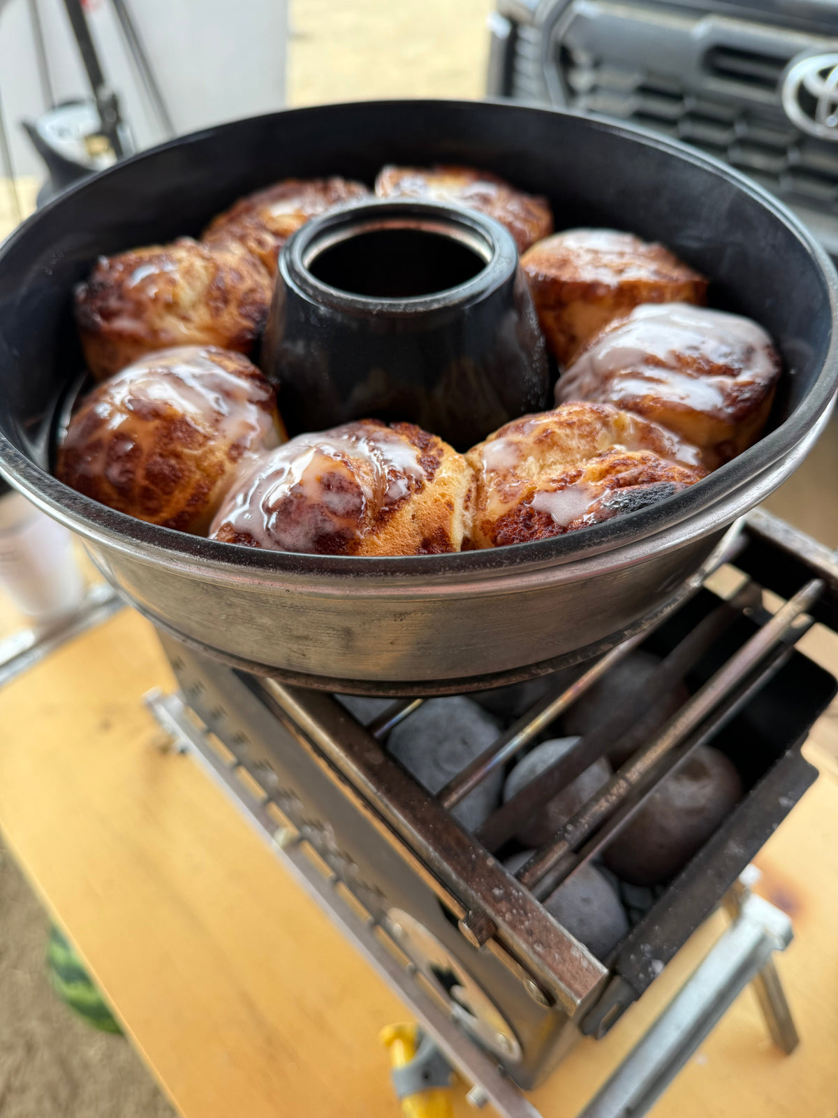 Overhead shot of pastries arranged in the Omnia oven's baking ring set over a firebox