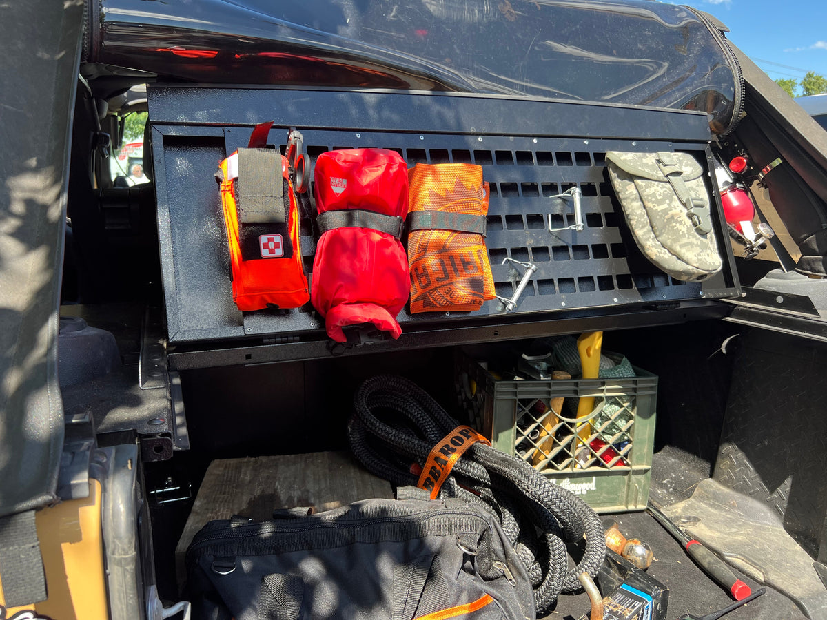 Folding top MOLLE panel with red and orange recovery bags under the lid